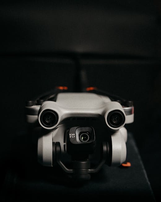 Close-up of a drone camera lens in focus against a dark background, emphasizing technology.
